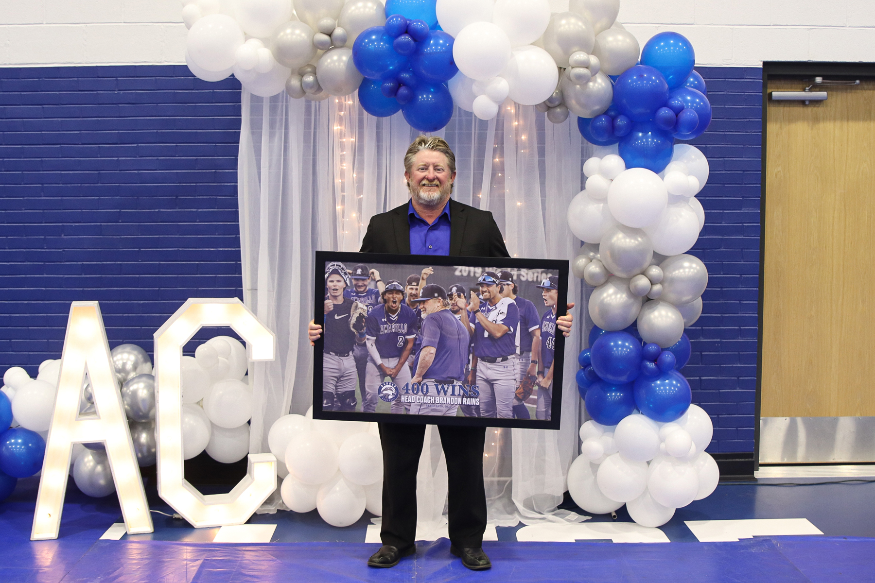 Rains with 400 wins poster at athletics banquet